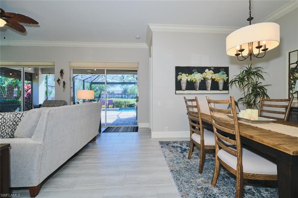 Dining space featuring a sunroom, ornamental molding, and ceiling fan