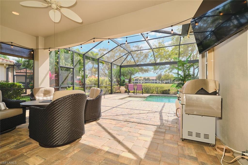 View of patio with an outdoor pool, a ceiling fan, a lanai, and a sunroom