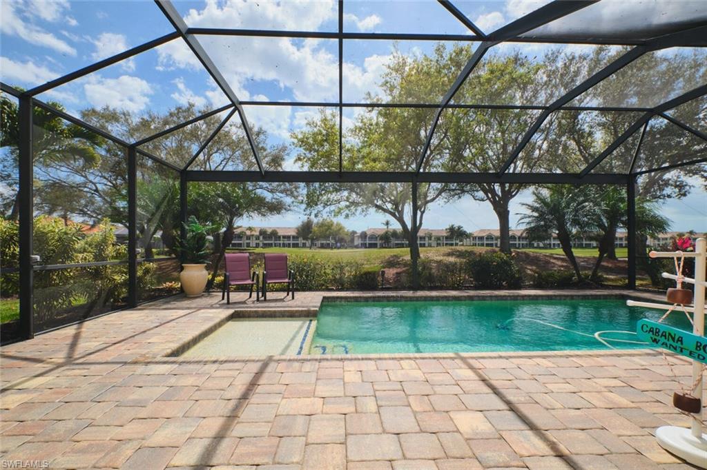 Swimming pool with a lanai, a patio, and a sunroom