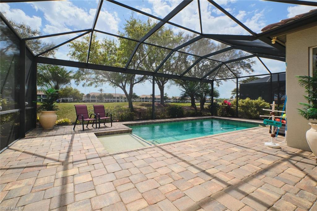 Outdoor pool with a sunroom, a patio, and a lanai