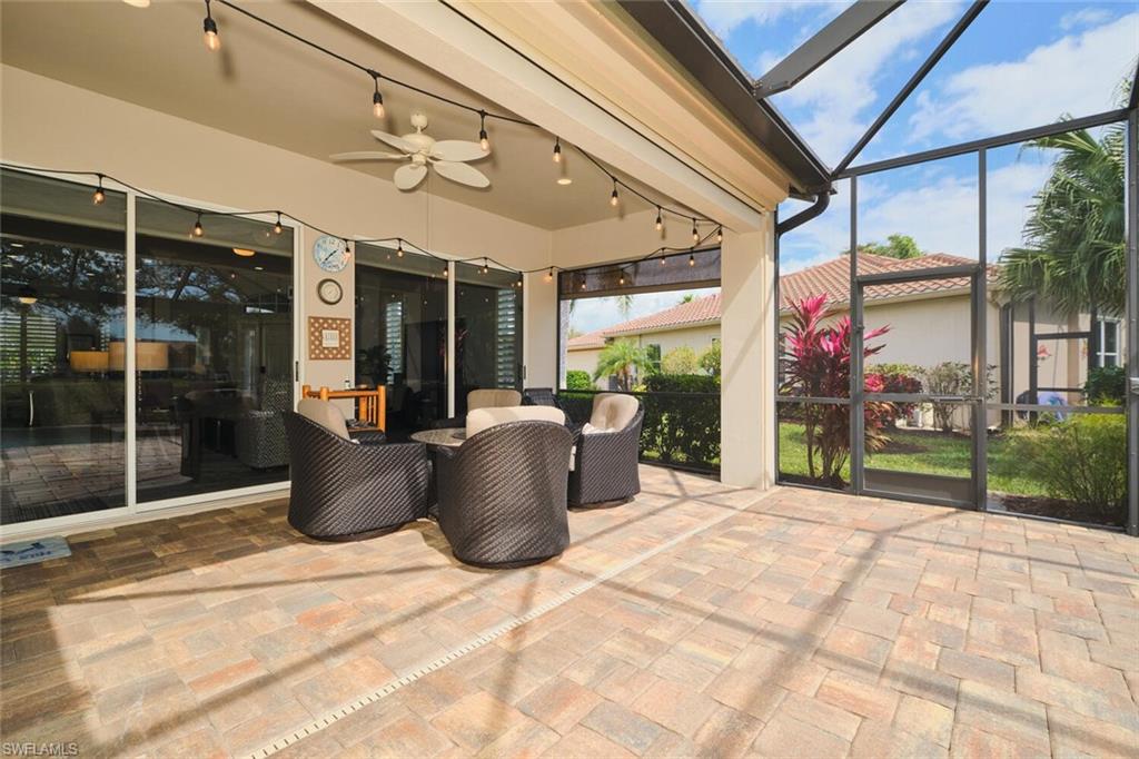 View of patio featuring a ceiling fan, a sunroom, and a lanai