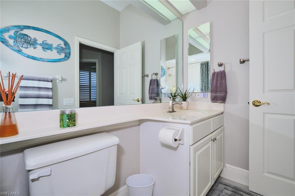 Half bathroom featuring vanity and toilet
