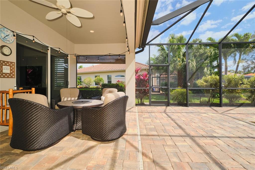View of patio / terrace featuring a ceiling fan, a sunroom, and a lanai