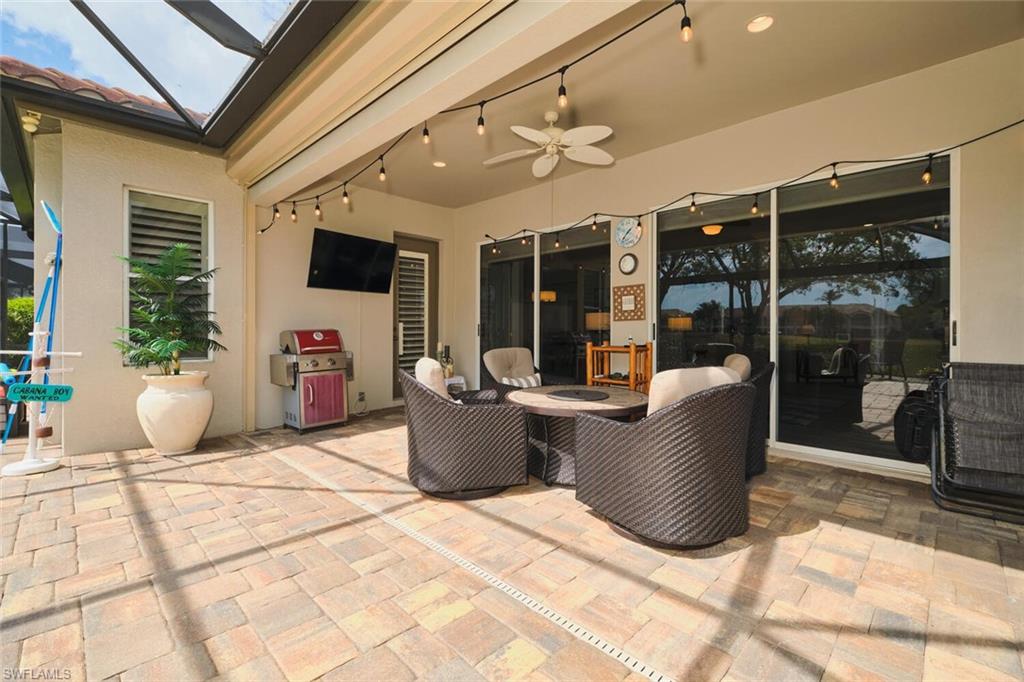 View of patio with a ceiling fan, a lanai, and area for grilling