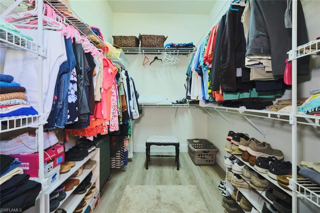 Walk in closet featuring light wood-style floors