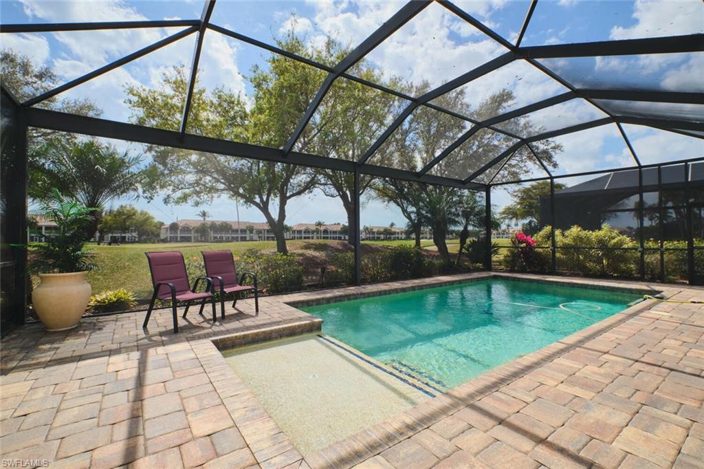 Outdoor pool featuring a lanai, a patio area, and a sunroom