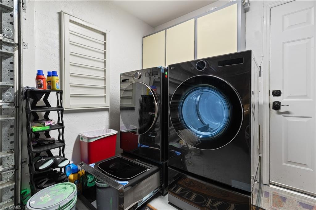 View of the Side Load Garage Laundry Corner with High End Stainless Washer w/Separate Delicate Hand Washer Drawer and High End Side Load Dryer.  NOTE A NEW/ NEVER USED Generator is in the Garage