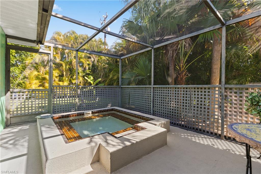 View of Mansard Screened Separate Heated Spa with newly installed water timing system