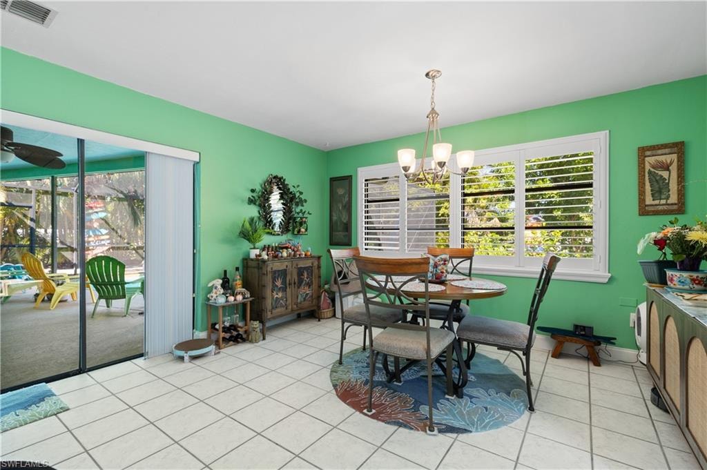 View of the attractive Dining Room with Plantation Shutters to the Rear Landscaped Yard and Slider to the Lanai/Pool Deck.