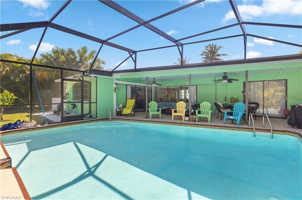 View of Screened Pool Cage, Crystal Clear Pool with Newly Installed Water Timing System, with New Screened Pool Cage and Lanai/Outdoor Dining, and New Electric Pool Heater.