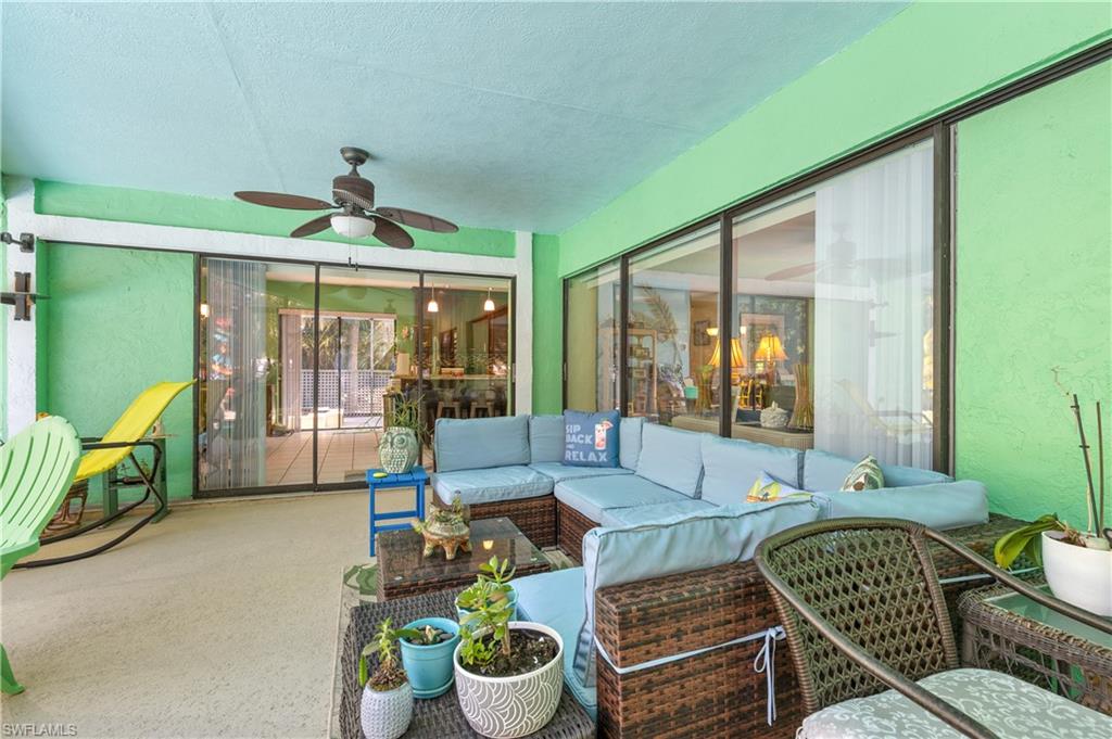 View of the Lanai/Pool Deck with Outdoor Dining and Seating and Pocketing Sliders to Living Room plus Pocketed Slider to Dining Room/Kitchen [Note Newly Painted Whole House Exterior]