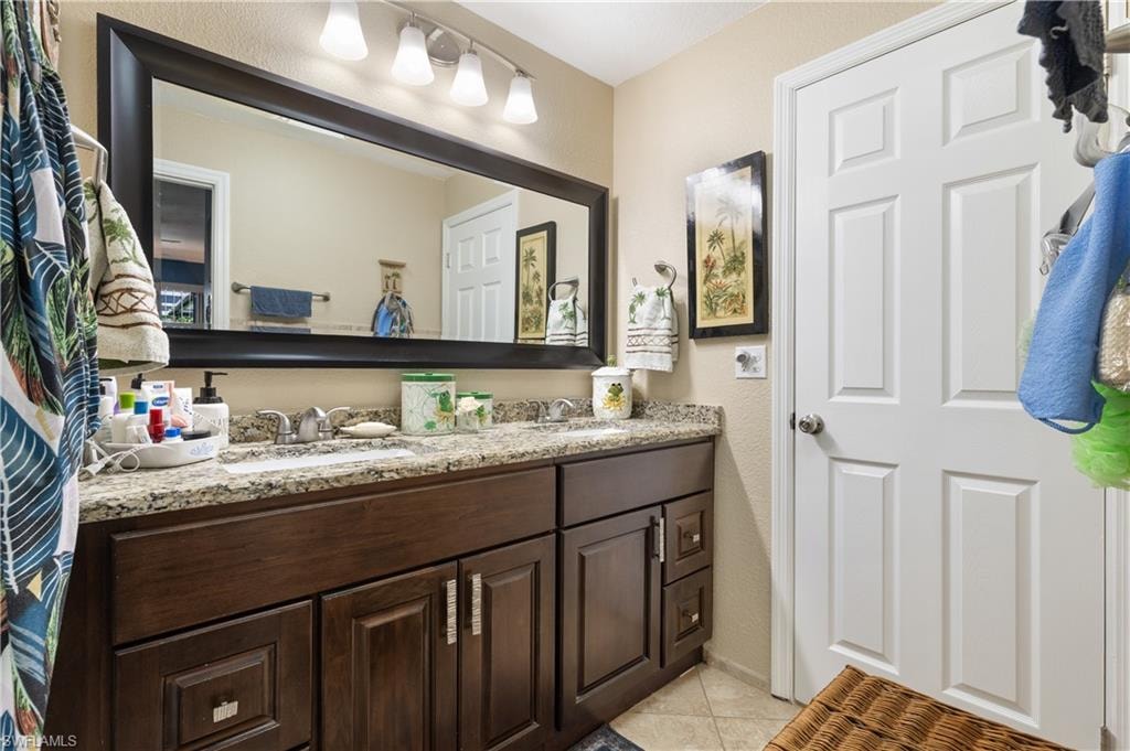 View of the Eastside Granite Vanity and Full Framed Mirror with Doorway to the Hallway [Note again the Attractice Vanity Hardware] [and ALL NEW MOEN FAUCETS THROUGHOUT THE HOME.]