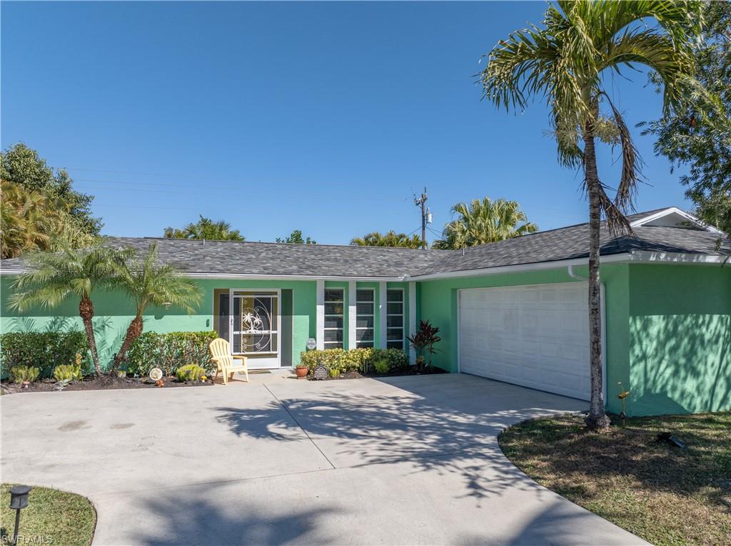 Front Elevation with Two-Car Side Garage with Garage Door Opener and Hurricane Paneled.. .  Note New Roof , New Ornamental Palm Screen Door.\ and New Whole House Exterior Painted]