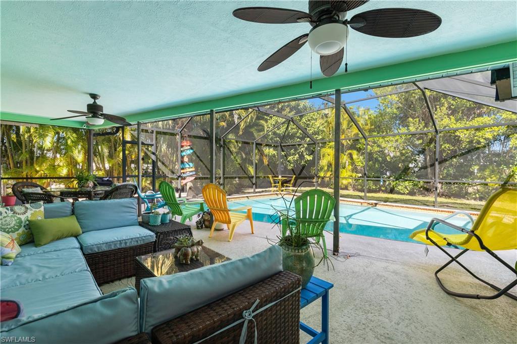 View the the Lanai/Pool Deck and Heated Pool with New Screen Cage, and outdoor shower [Note A New Water Timing Systems for both Pool and Spa]