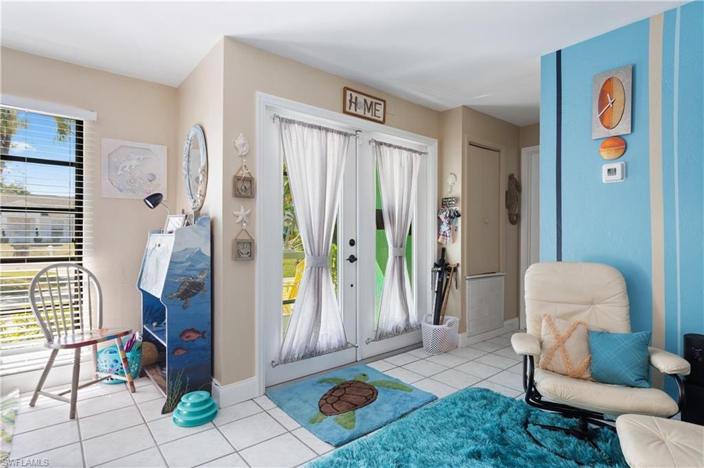 View of Double Door Entry inside Screened In Foyer.  East Side Ensuite Entry is to its Left [on the Right in this pic] NOTE: a Newly Installed Electric Hardwired Ring Security Setup and Newly Painted Interior