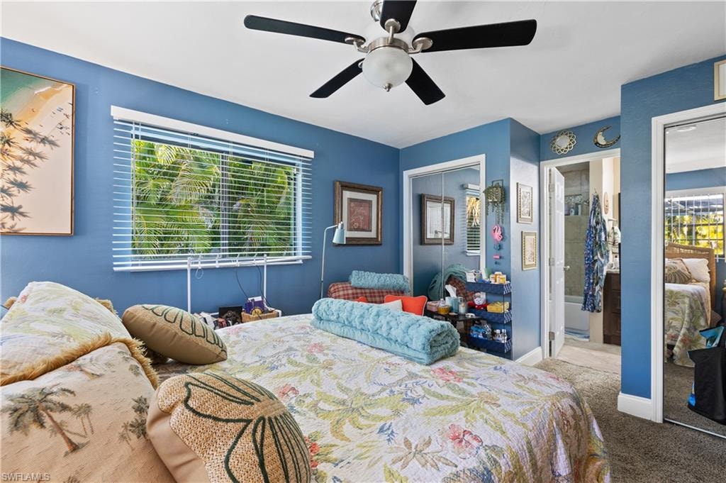 View of the Sunlit Eastside Ensuite with Lighted Ceiling Fan with Double  Newly Installed BiFold Mirrored Closets and Doorway to Eastside Bath.