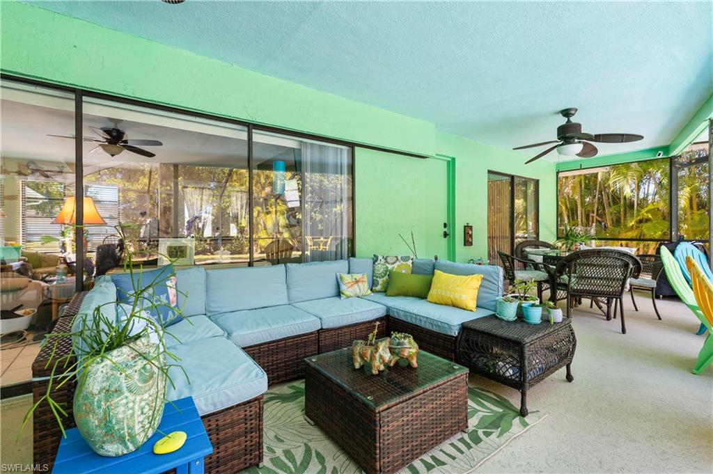 View of the Lanai/Pool Deck with Outdoor Dining and Seating and Pocketing Sliders to Living Room plus Slider to East Ensuite