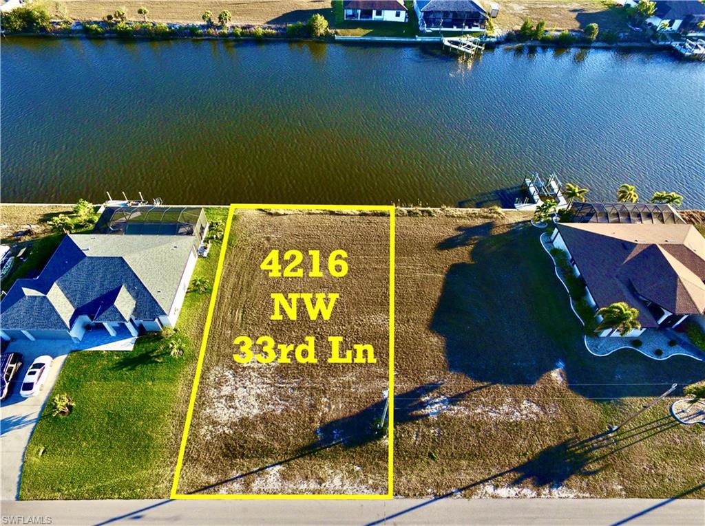 View of property location featuring property boundaries highlighted and a nearby body of water