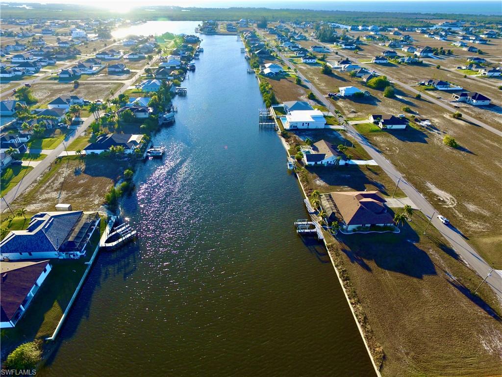 View of property location featuring a large body of water and nearby suburban area