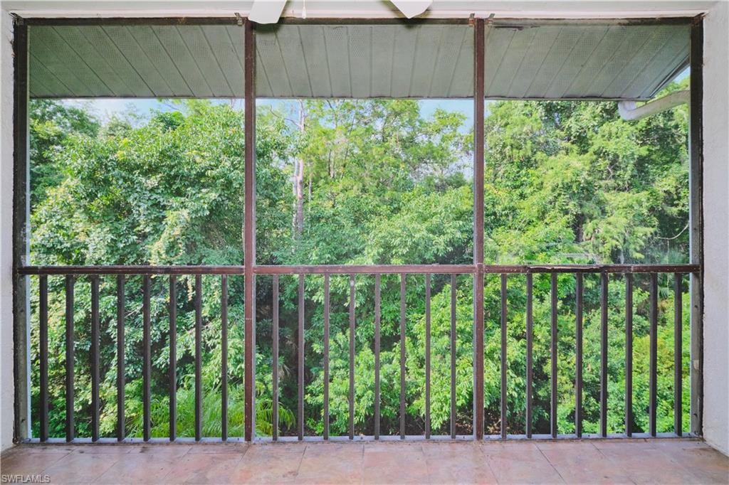 Tiled balcony with a private preserve view.