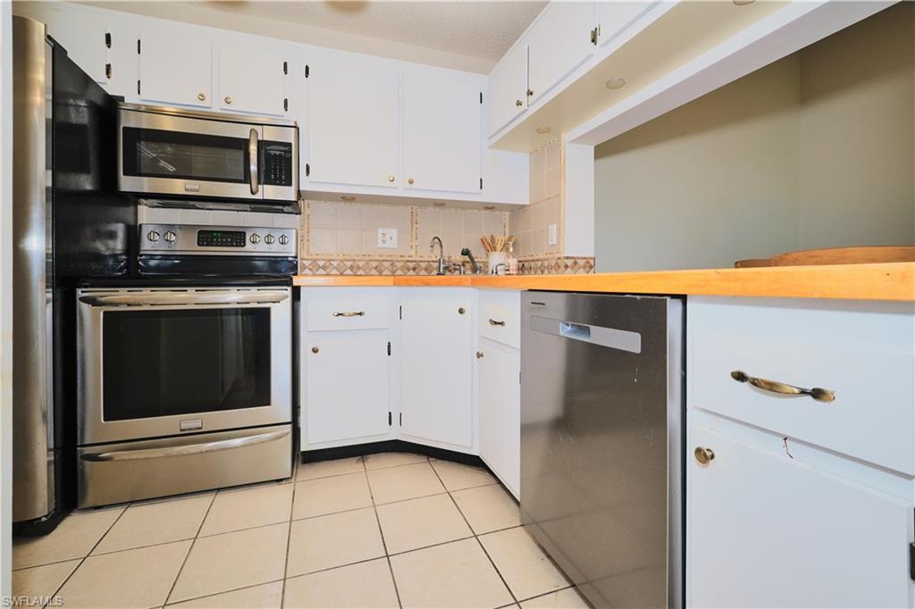 Kitchen features stainless steel appliances with new dishwasher.