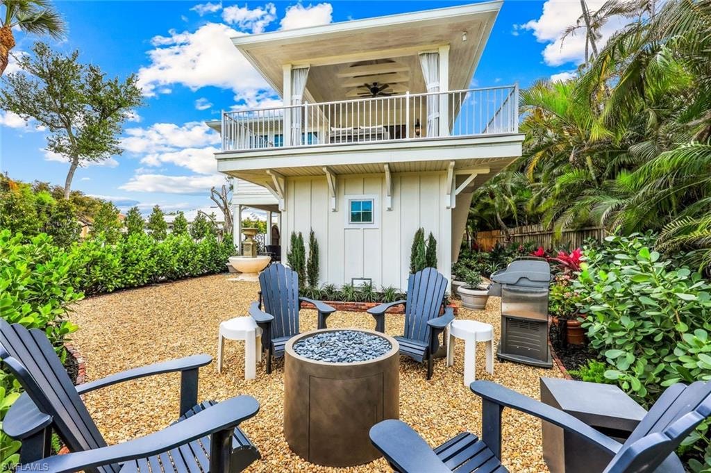 View of patio / terrace with a balcony, a grill, and fence