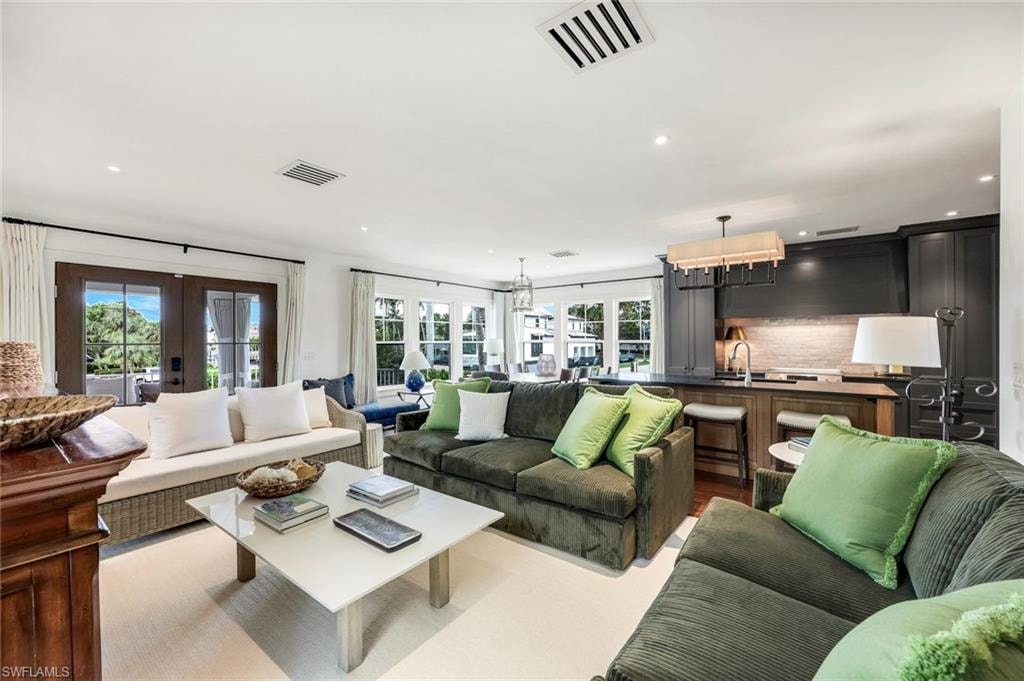 Living area featuring recessed lighting, visible vents, and french doors