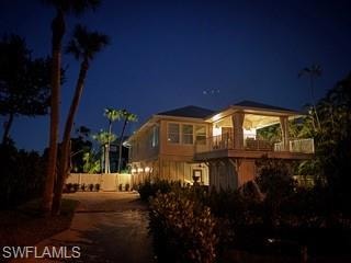 Back of house at night with fence