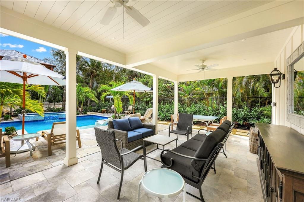 View of patio with outdoor lounge area and a pool with connected hot tub