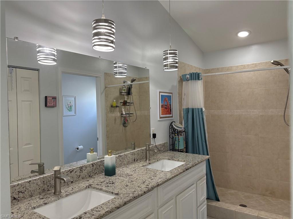 Bathroom with double vanity and a stall shower