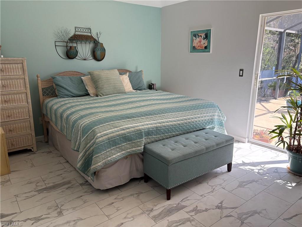 Bedroom featuring access to exterior and light marble finish floors