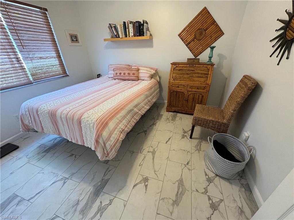 Bedroom with light marble finish floors