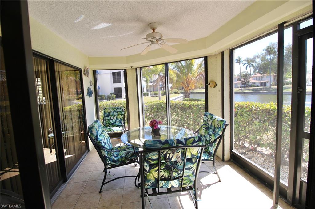 Screened lanai overlooking lake with fountain