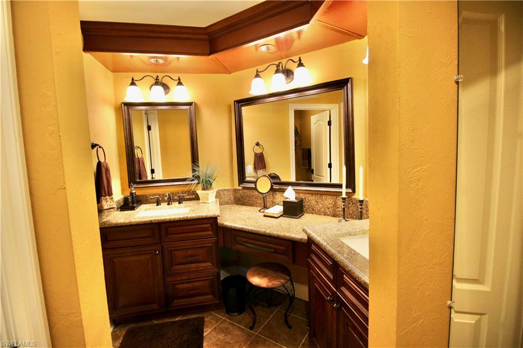 Full bathroom with double vanity, make up counter and custom woodwork