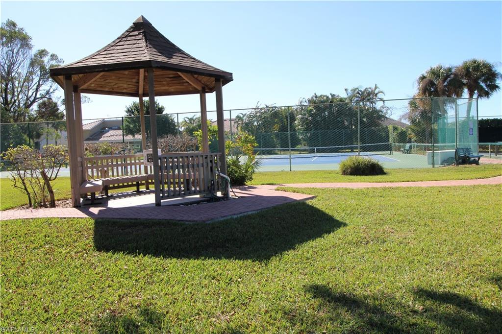 View of property's community featuring a tennis court, a patio, and a gazebo
