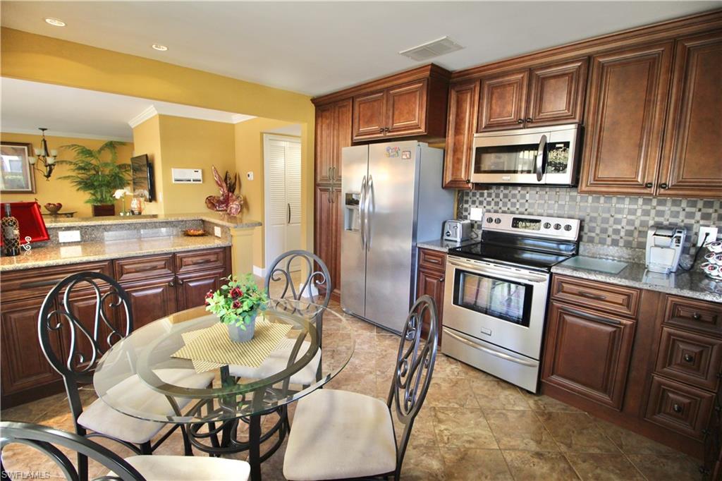 Kitchen with stainless steel appliances, tons of cabinets, granite countertops