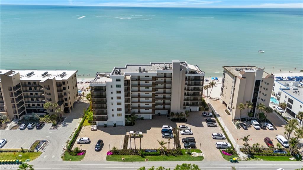 Aerial view of apartment complex / building and a nearby body of water