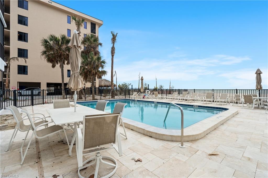 Community pool featuring a patio