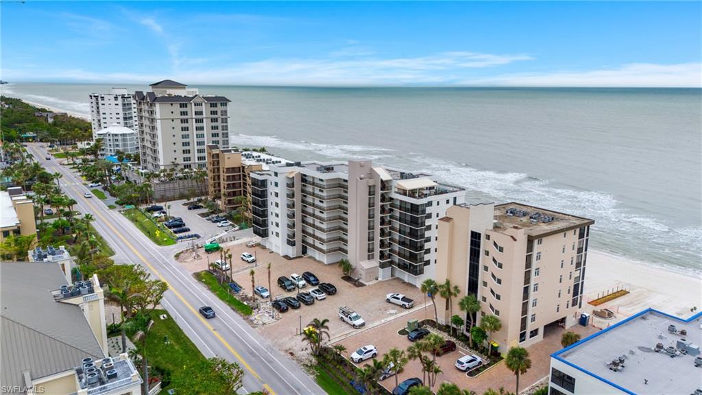 Bird's eye view of apartment complex / building and extended coastline