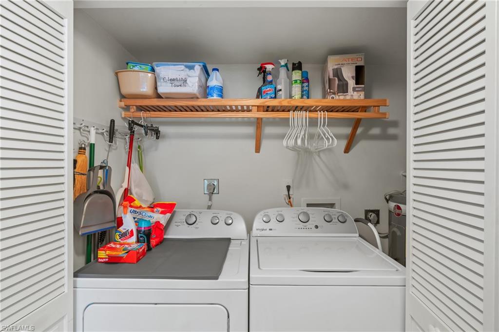 Laundry area with washer and clothes dryer and water heater