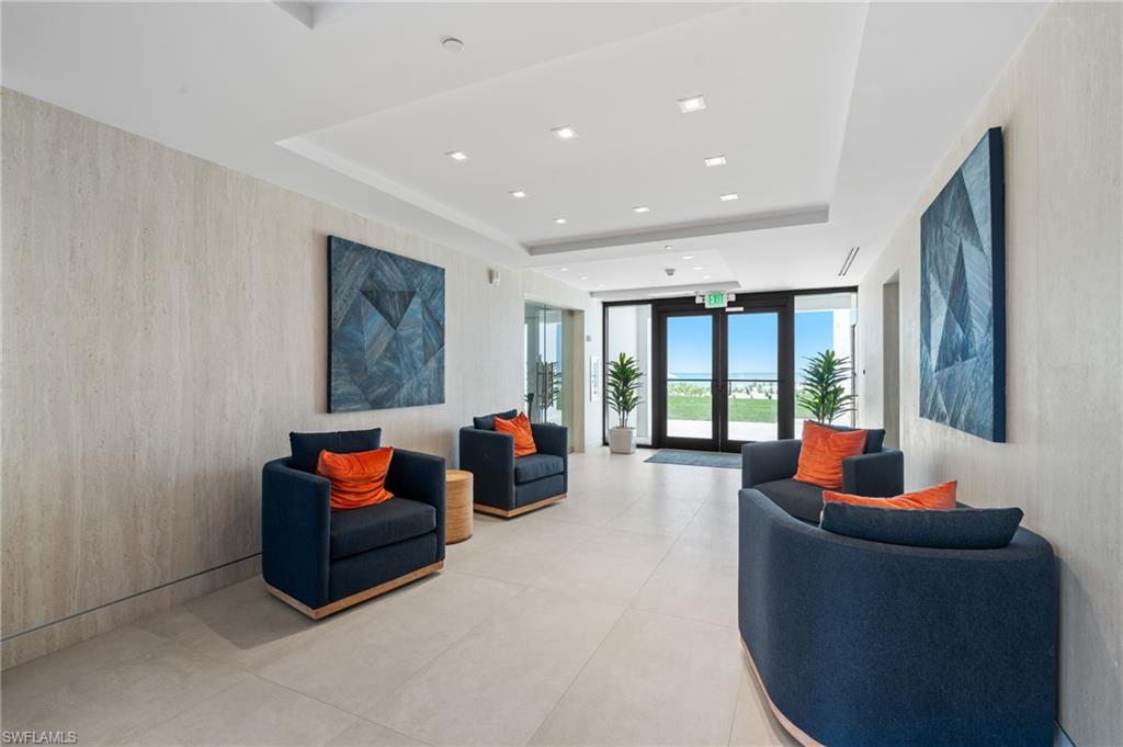 Community lobby with floor to ceiling windows, a raised ceiling, and recessed lighting