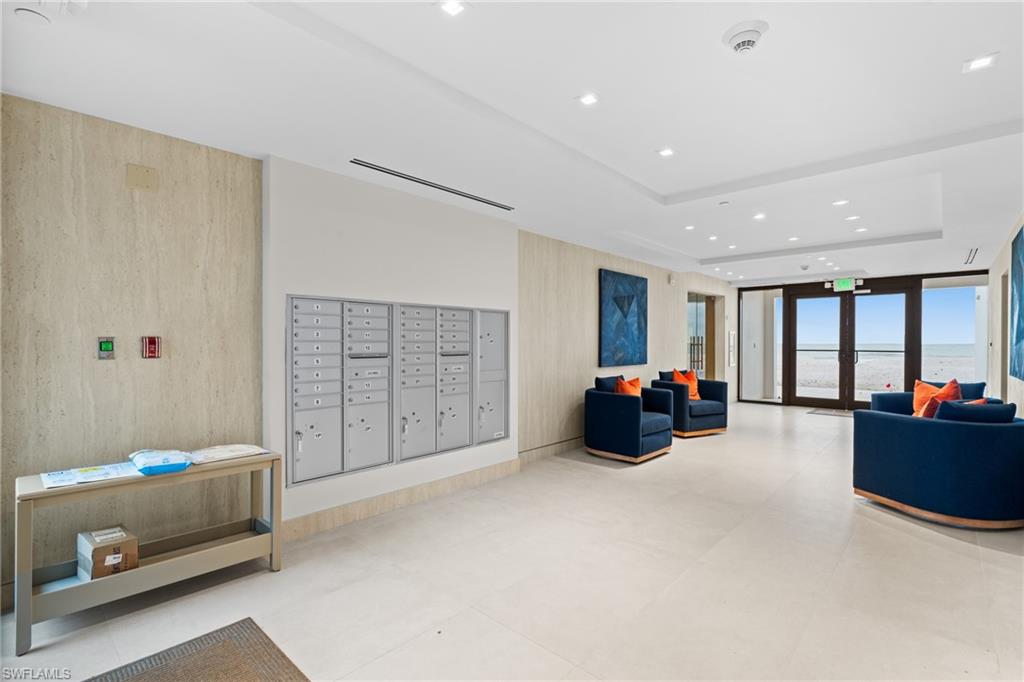 Lobby with expansive windows, a tray ceiling, and recessed lighting