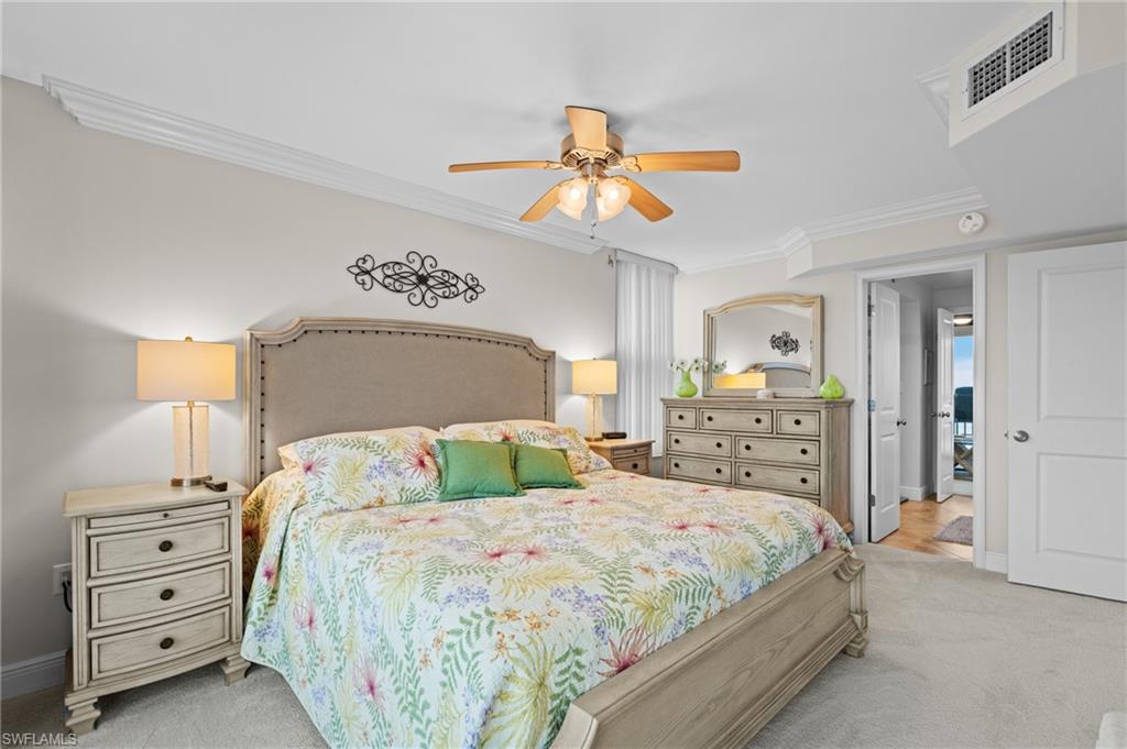 Bedroom featuring ornamental molding, light carpet, and ceiling fan