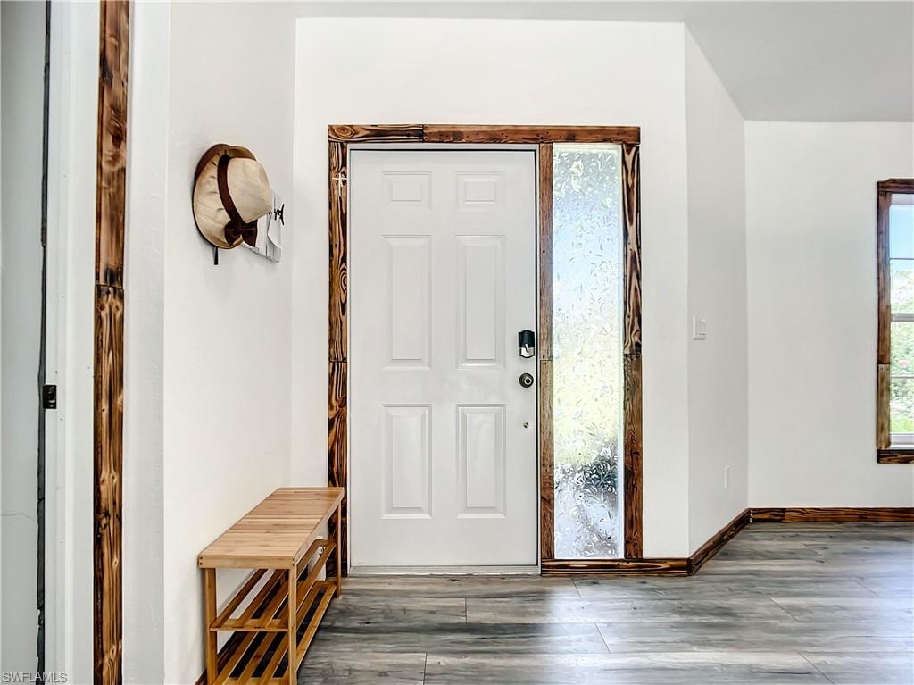 Foyer entrance featuring hardwood / wood-style floors and baseboards