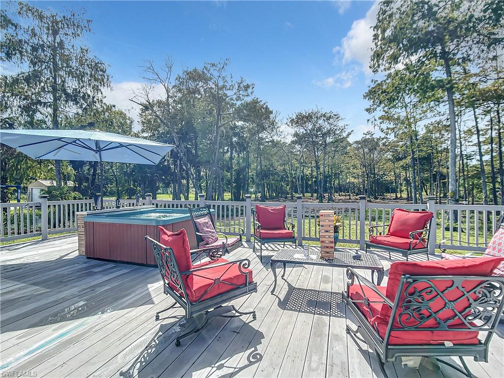Wooden terrace featuring a hot tub