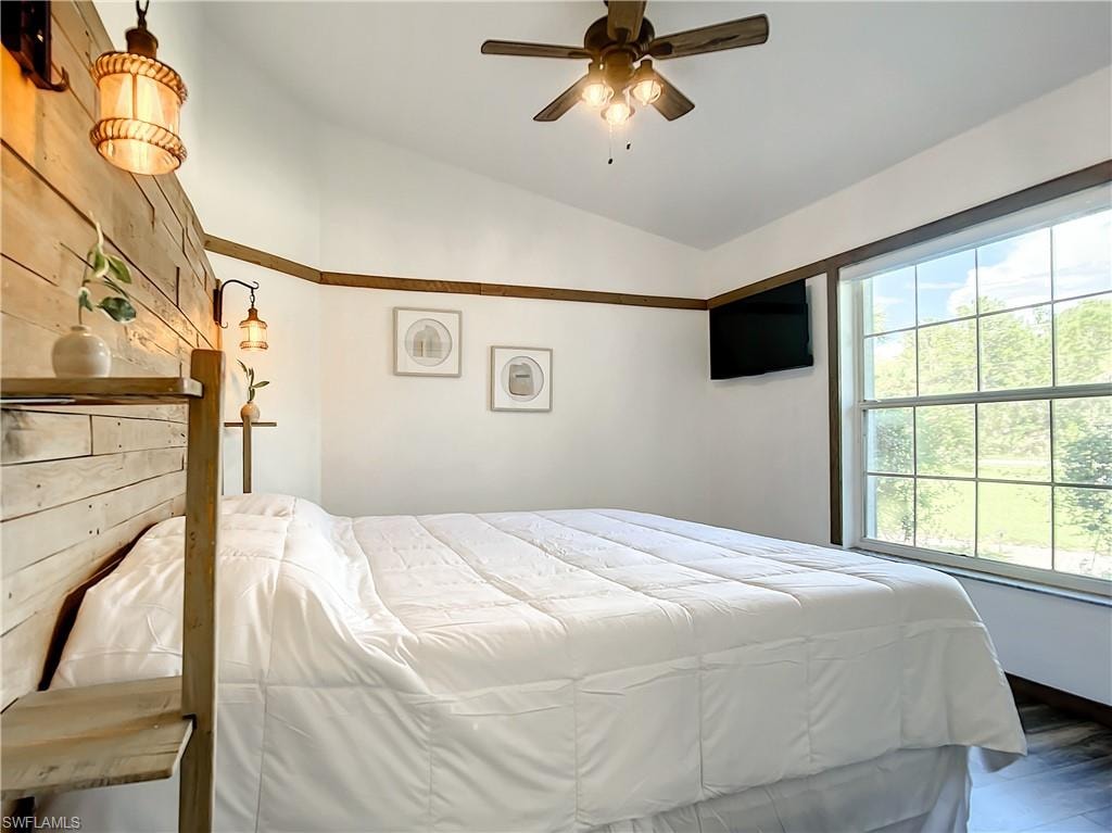 Bedroom featuring lofted ceiling and a ceiling fan