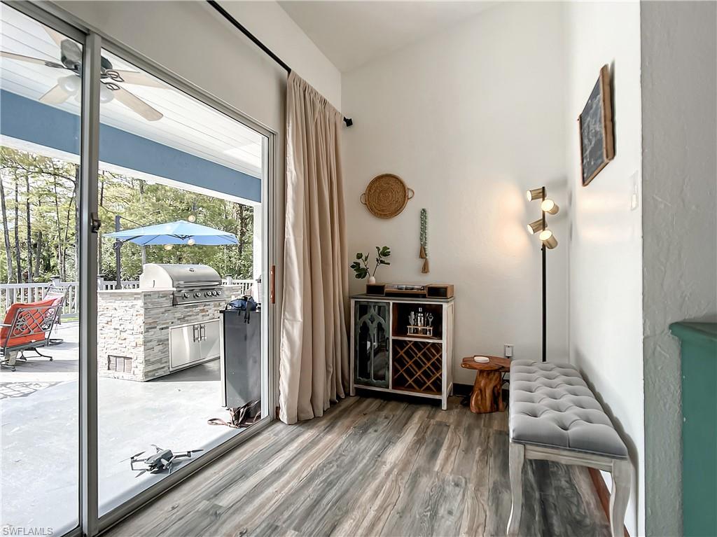 Doorway featuring wood finished floors and ceiling fan