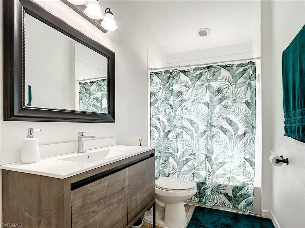 Bathroom with vanity and shower / bath combination with curtain
