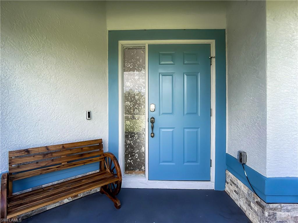 Property entrance with stucco siding and stone siding