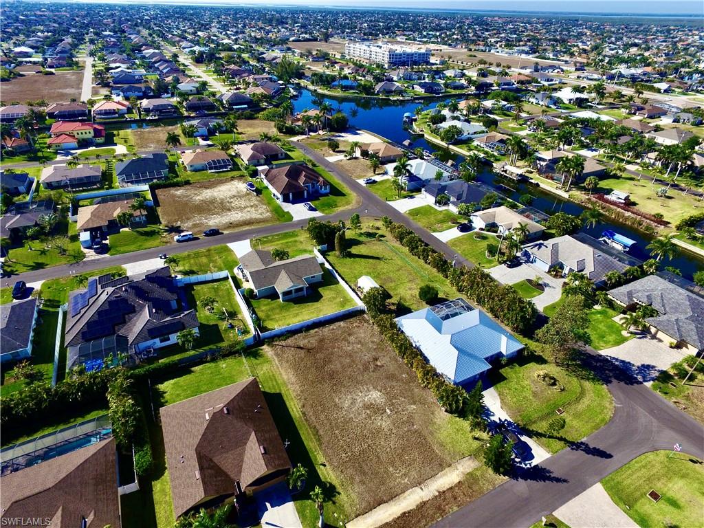 Aerial overview of property's location with nearby suburban area and a nearby body of water